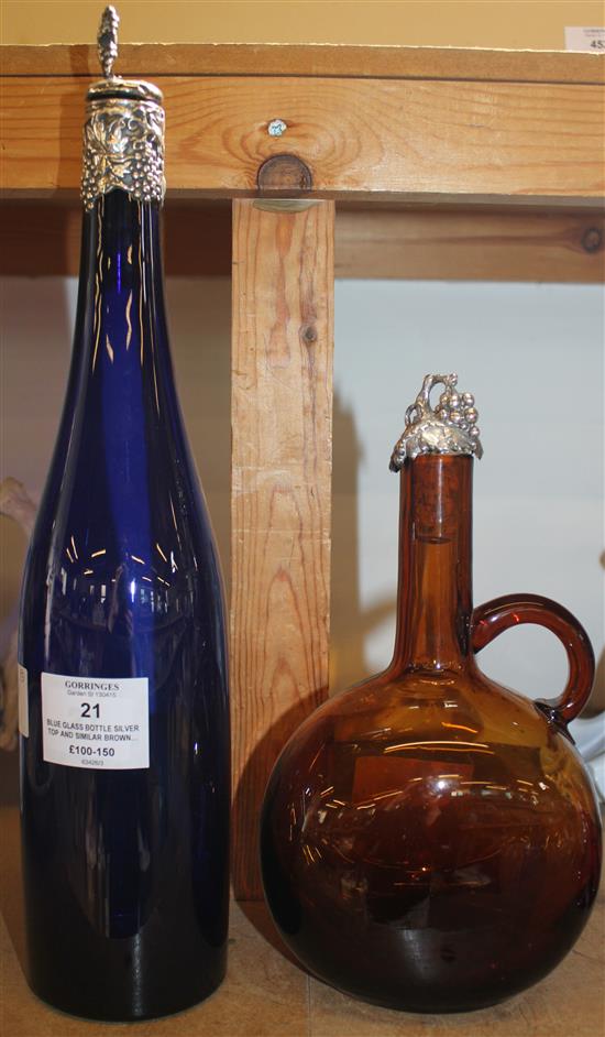 Blue glass bottle silver top and similar brown glass decanter